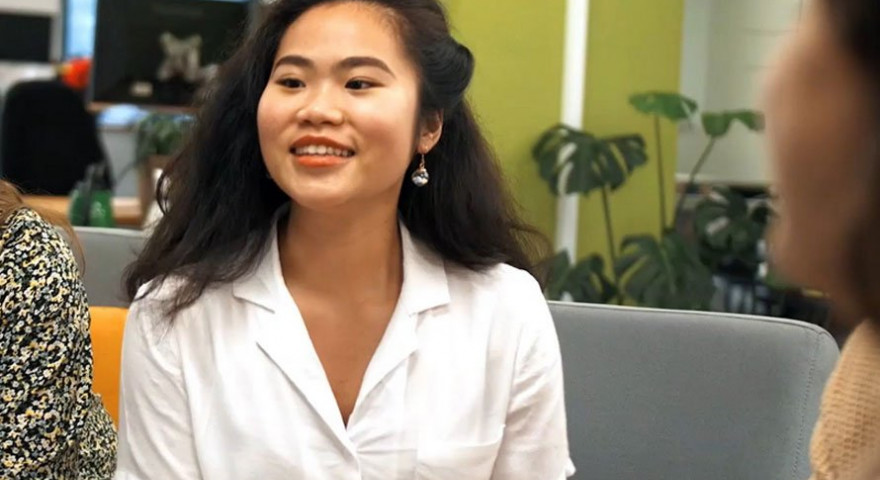 Anh Duong wearing a white shirt and smiling at the camera
